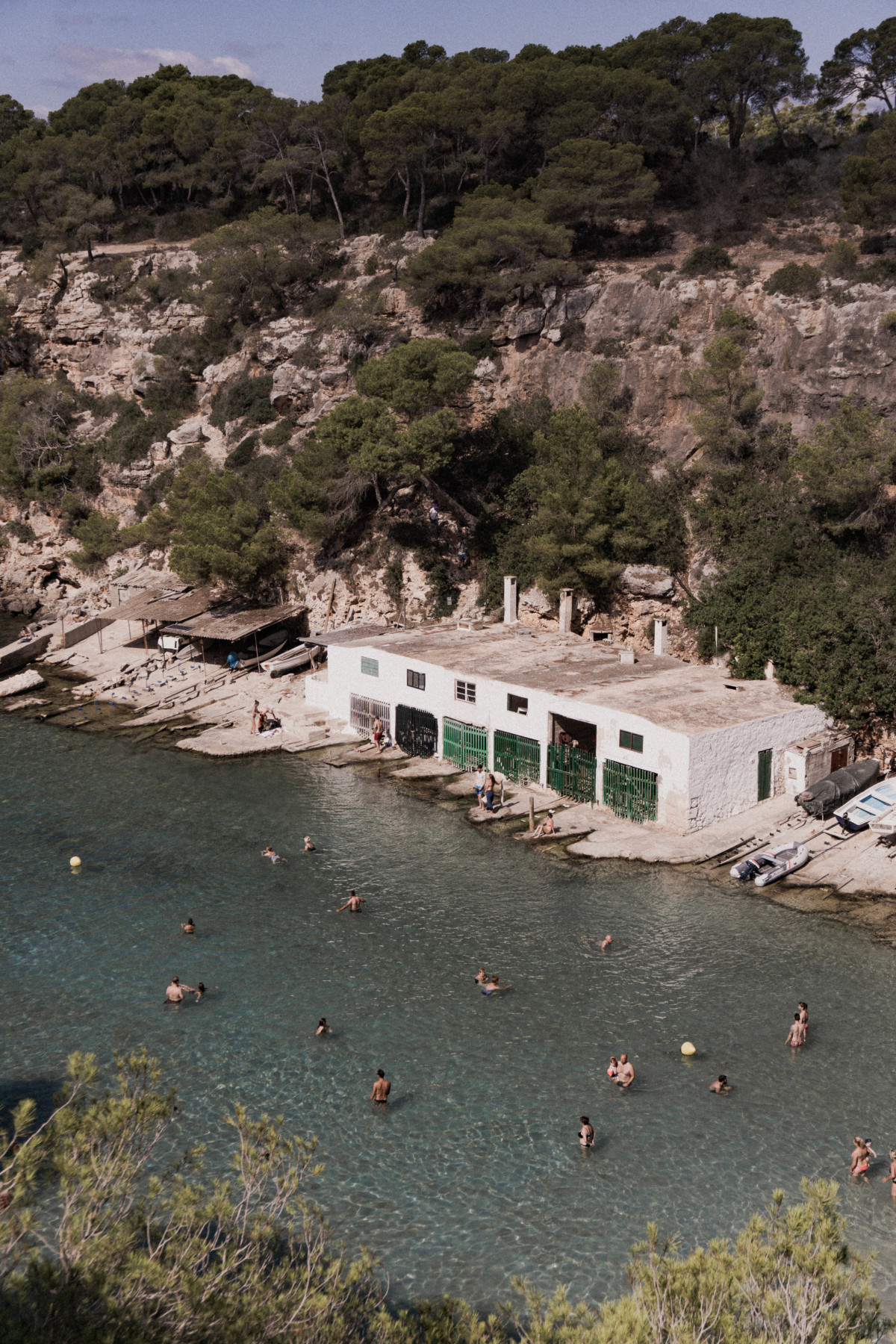 Looking down onto the white boathouses at Cala Pi