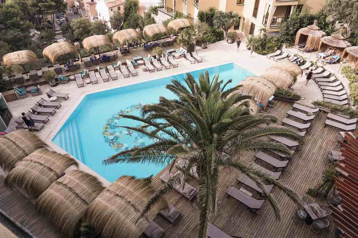 Review of Bikini Island and Mountain Hotel in Port de Soller. An aerial view of the blue pool with a flowery peace sign decoration in the bottom