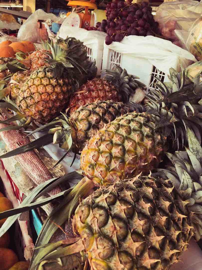 pineapples at a market stall in Thailand.