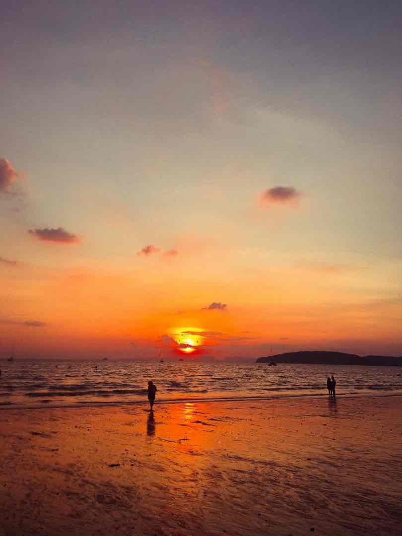 A orange sunset at the beach in Thailand. This is a great place to go when you've saved for a holiday using payday habits.
